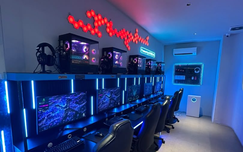 The Battlezone: RTX 4070 Super PCs under blue desk lighting and a red LED wall