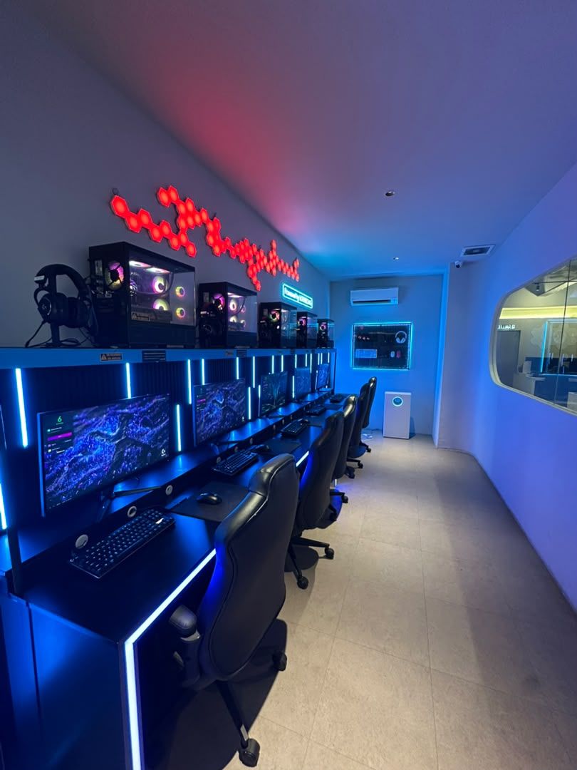 One of the two Battlezone rooms: five PCs in a row with a glass window onto the main floor